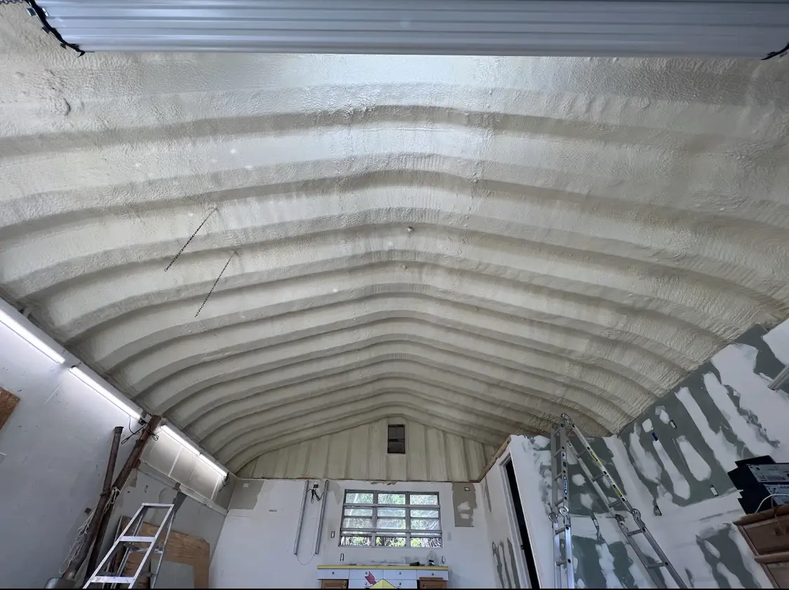 Spray polyurethane foam applied to the underside of a metal roof deck in Enfield